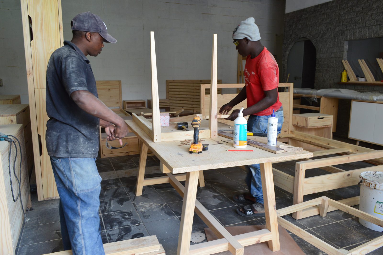 Cross Grain makers assembling a solid-pine table in the Cape Town workshop